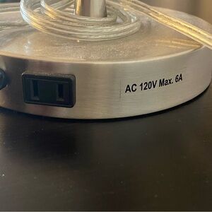 Silver desk lamp with outlet connected